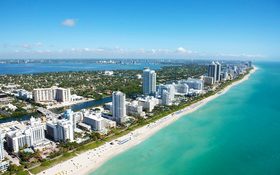 Aerial view of stunning buildings next to a white beach at Miami Beach, FL, USA