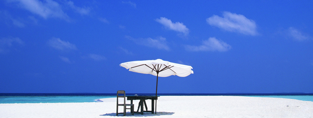 Beach tiki umbrella on sandy beach