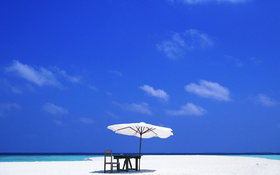 Beach tiki umbrella on sandy beach