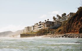 Houses by the beach, surrounded by palm trees at Malibu