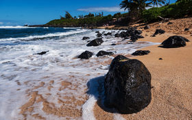 Ocean waves crashing on lava rocks on Ho’okipa Beach in Maui, Hawaii