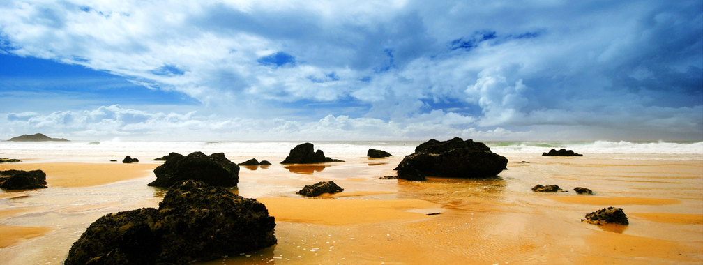 Orange ocean and black rocks beach wallpaper