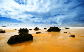 Orange ocean and black rocks beach wallpaper