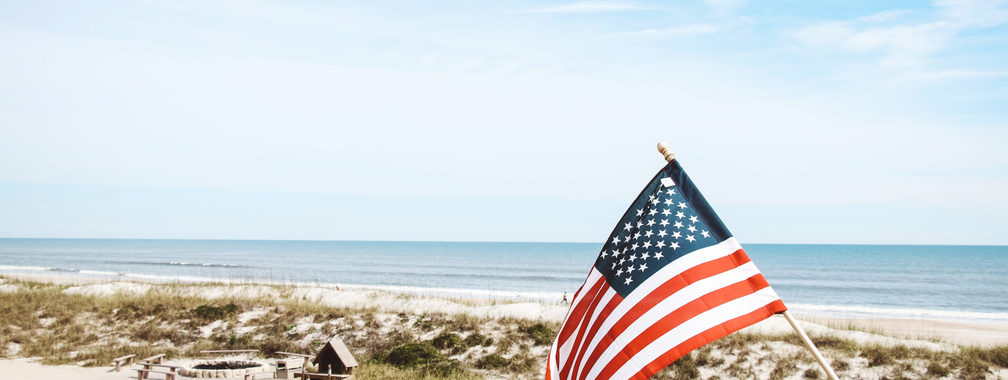 Patriotic flag beside the Atlantic coast in Jacksonville Florida