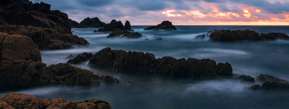 Rocks covered with mist around Corbière Lighthouse, Jersey