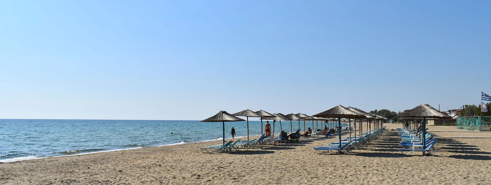 Sandy shore and clear waters at Nea Flogita beach wallpaper