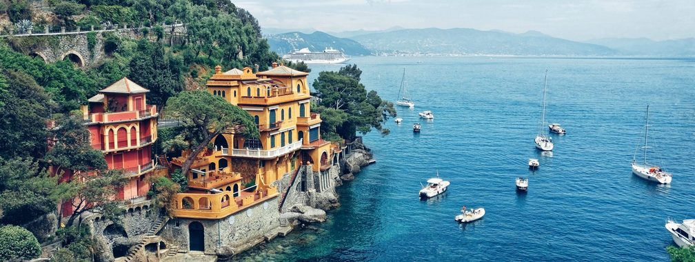 Sea shore cliffs with blue water in Portofino, Italy