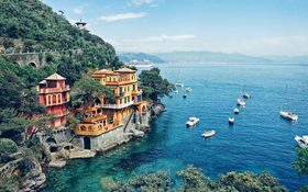 Sea shore cliffs with blue water in Portofino, Italy