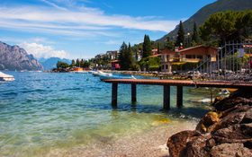 Small town Torbole on lake Garda with blue sky in Italy