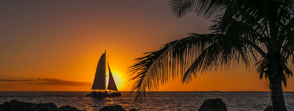 Sunset on a gorgeous beach with a ship sailing at Key West, USA