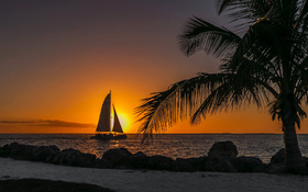 Sunset on a gorgeous beach with a ship sailing at Key West, USA