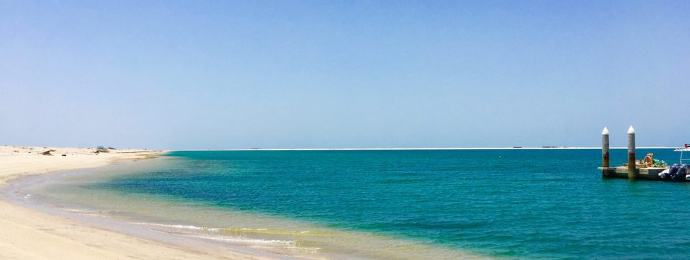 Turquoise waters and soft white sand of Dubai beach