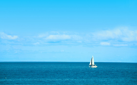 White Sailboat on Blue Ocean Beach Background