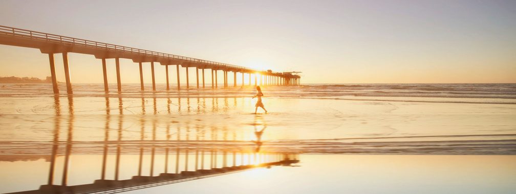 Woman walking on a beach in San Diego, United States