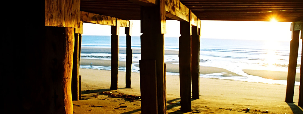 Wooden bridge on the beach background